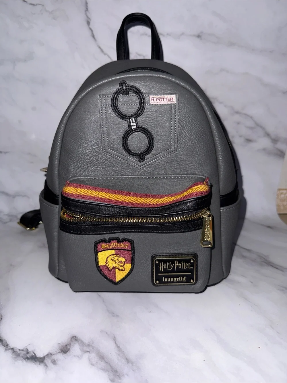 Loungefly Gray Harry Potter Gryffindor Mini Backpack with Red and Gold Accents